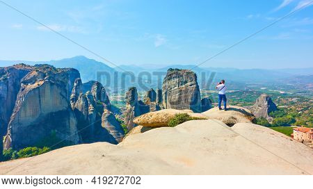 Meteora,  Greece - September 17, 2019: Man taking photo  at panoramic view point at Meteora
