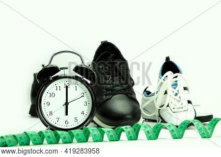 Watch And Sneakers Close Up - Fitness Concept. At The Alarm Clock 6.00. Time To Run. Healthy Lifesty