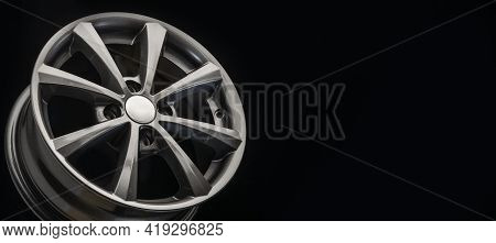 The New Alloy Wheel Is Gray On A Black Background. Auto Parts And Tuning. Long Layout Copyspace