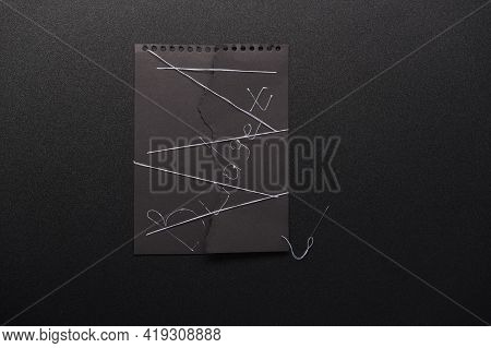 Torn Budget And Sewn With White Thread. Sew Up A Black Sheet Of Paper With White Threads. Top.