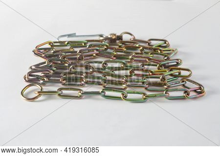 The Iron Chain With Large Links Lies On A White Background.