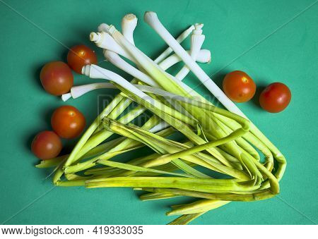 Young Garlic And Cherry Tomatoes. Young Garlic Belongs To The Liliaceae Family, Like Onion And Leek.
