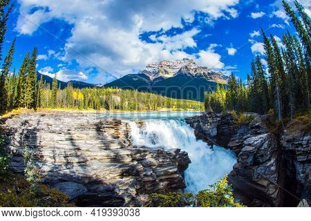The famous Athabasca Falls. Mountain, river and waterfall make up magnificent landscapes. Rocky Mountains of Canada. Jasper Park. Travel and ecological tourism concept