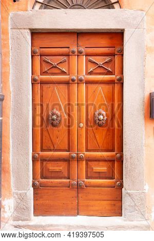 Beautiful Front Door. Wooden Door With Carved Flowers And Arrows In The Barga. Beautiful Door Of The