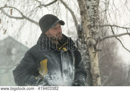 Portrait Of A Worker In A Black Cap