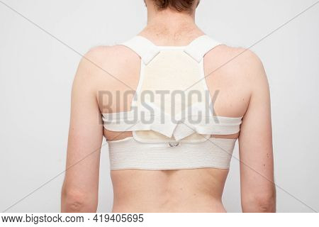 A Back O Fman With A Curvature Of The Spine With A Corrective Corset.