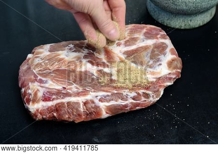 Homemade Capicola. Dry-cured Pork Loin Step-by-step Recipe. A Hand Sprinkles A Salted Piece Of Meat 