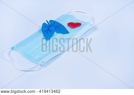 Paper Lungs And Red Heart On Protective Mask, Blue Background. World Tuberculosis Day. Prevention Co