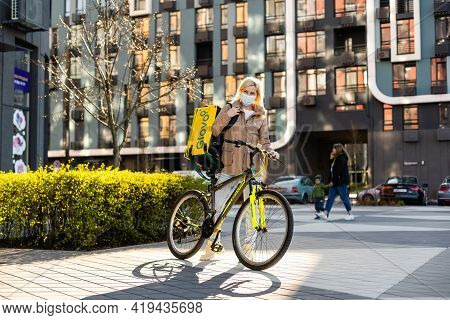 Kiev, Ukraine - April 28, 2021: Glovo Bike Courier On The Street. Delivery Of Glovo Delivery Service