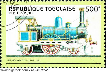 Togo - Circa 1996: A Stamp Printed In Togo Shows An Old Italian Railroad Steam Engine Locomotive Mad