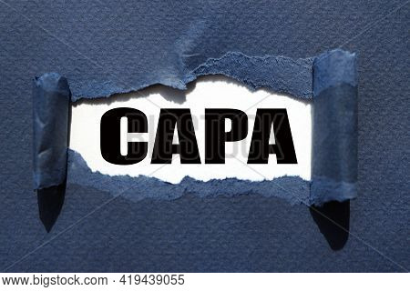 Capa Corrective And Preventive Action Plans. Text Inside Torn Blue Paper. White Sheet With Black Fon