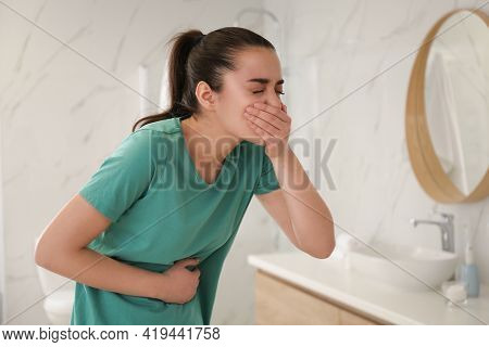 Young Woman Suffering From Nausea In Bathroom. Food Poisoning
