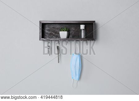 Wooden Hanger For Keys With Different Stuff On Light Grey Wall