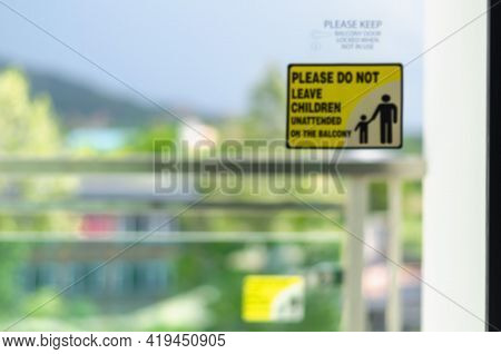 Blurred Images Of Symbols Placed On A Clear Glass Door. (please Do Not Leave Children Unattended On 