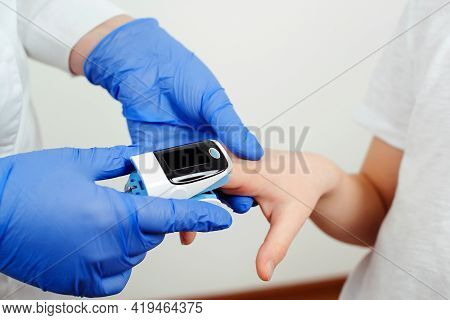 Doctor Measures The Oxygen Saturation Of Child. Concept Of Detection Of Asymptomatic Coronavirus. Pr