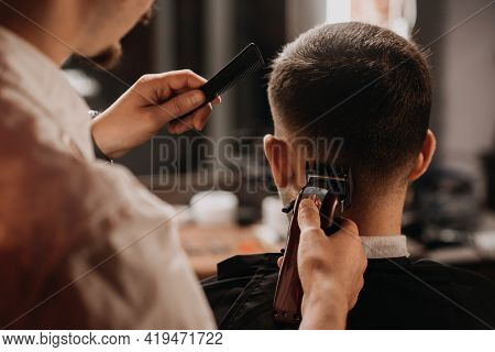 A Man Cuts His Hair At The Barber Shop