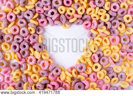 Multicolored Breakfast Cereal Loops Framing Heart Shaped Copy Space On White