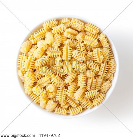 Uncooked Radiatori Pasta In White Ceramic Bowl Isolated On White Background With Clipping Path