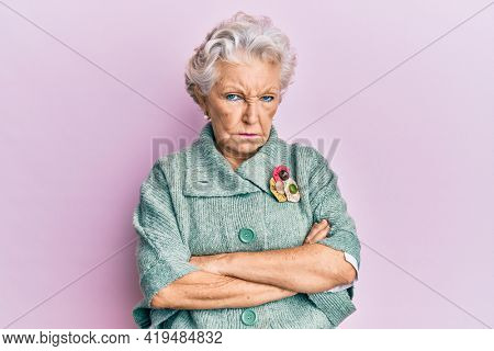 Senior grey-haired woman wearing casual clothes skeptic and nervous, frowning upset because of problem. negative person. 