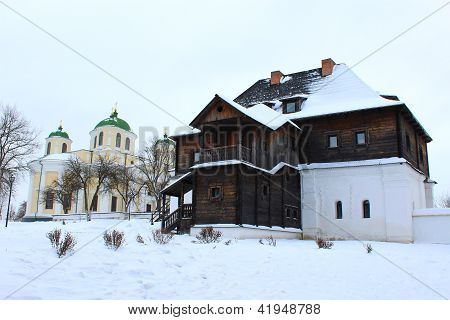 wooden house and beautiful church in winter in Ukraine