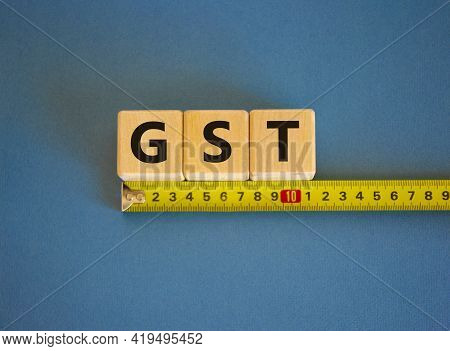 Gst, Goods And Services Tax Symbol. The Word Gst, Goods And Services Tax On Cubes Arranged Behind Th
