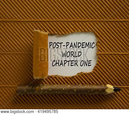 Post-pandemic World Symbol. Words 'post-pandemic World Chapter One' Appearing Behind Torn Brown Pape
