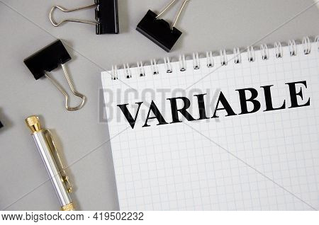 The Variable Written Word On Notepad And Gray Background. Word