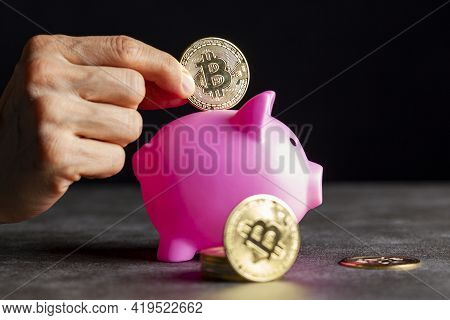 Concept Image For Using Digital Crypto Currency For Savings. A Caucasian Woman Is Putting A Symbolic