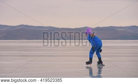 The Child Train On Ice Professional Speed Skating. The Girl Skates In The Winter In Sportswear, Spor
