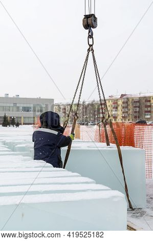 Slinger In A Blue Jacket Unloading Ice Blocks