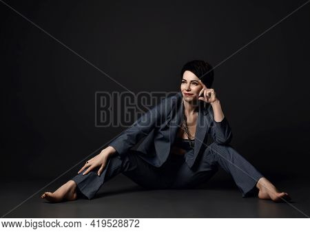 Cheerful Short Haired Brunette Businesswoman In Smart Casual Suit On Naked Body Sits On Floor With L