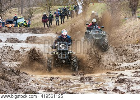 Afipsip, Russia - October 31, 2020: Sportsmen On Quad Bikes Drive Splashing In Dirt And Water At Mud