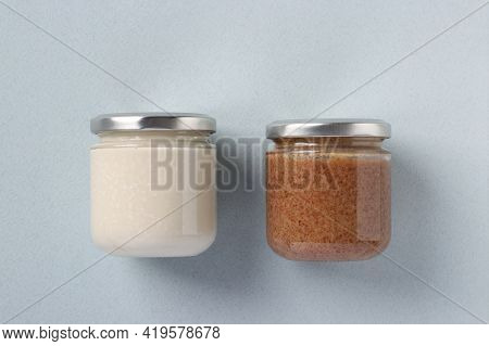 Vegan Organic Paste Of Peanuts And Coconut In Glass Jars On Light Blue Background. Dagestan Cuisine.