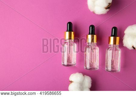Serum Or Oil Bottle With Pipette And Cotton Twig On Pink Background. Beauty Product, Skin Care Conce