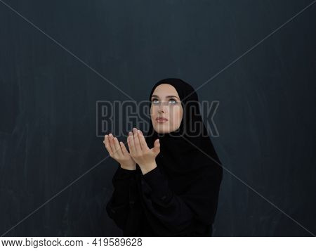 Portrait of young Muslim woman making dua