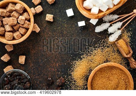 White Sugar, Cane Sugar Cubes, Caramel In Bamboo Bowl On Dark Brown Table Concrete Background. Assor