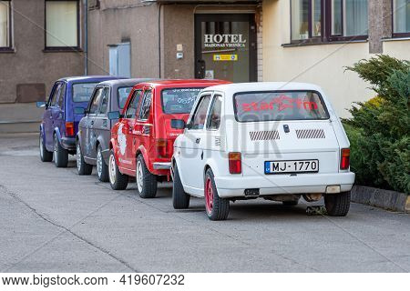 Madona, Latvia - May 01, 2021: Several Colorful Oldtimer Rental Cars Fiat 126 Parked In The Yard