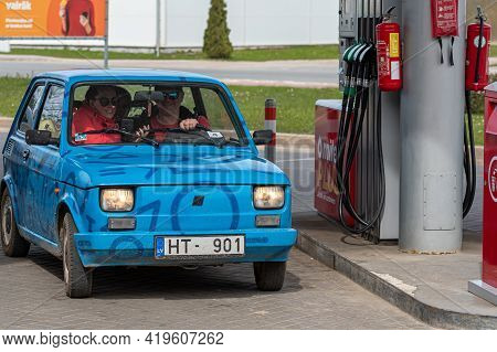Gulbene, Latvia - May 02, 2021: A Colorful Vintage Car Fiat 126 Refueling At The Gas Station