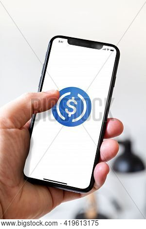 Paris - France - March 23, 2021 : Hand Holding Iphone Smartphone With Usdc Crypto Currency Logo