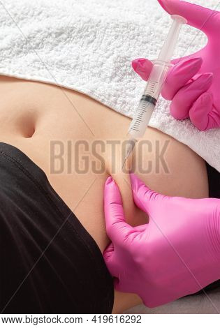 A Doctor Of Aesthetic Cosmetology Makes Lipolytic Injections To Burn Body Fat On A Woman's Stomach A