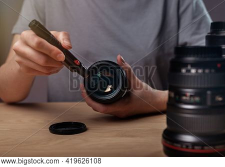 Female Hands Cleaning Camera Lens With Black Professional Brush, Closeup, Removing Dust And Dirt
