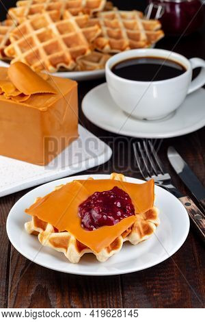 Homemade Waffles With Norwegian Brown Cheese And Lingon Jam, On A Wooden Background, Vertical