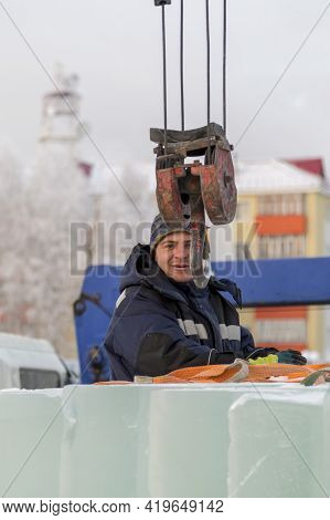 A Portrait Of A Fitter In A Blue Jacket At The Hook