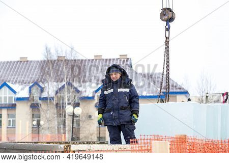 A Portrait Of A Fitter In A Blue Jacket At The Hook