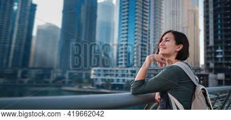 Happy Young Female Traveler In The Big City Of Dubai, Uae