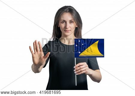 Happy Young White Woman Holding Flag Of Tokelau And With A Serious Face Shows A Hand Stop Sign Isola