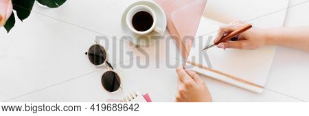 Columnist writing on a book