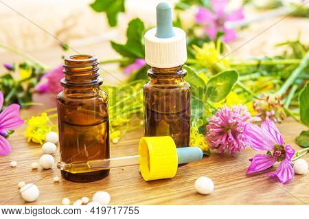 Medicinal Herbs, Oils In Small Bottles Homeopathy. Selective Focus