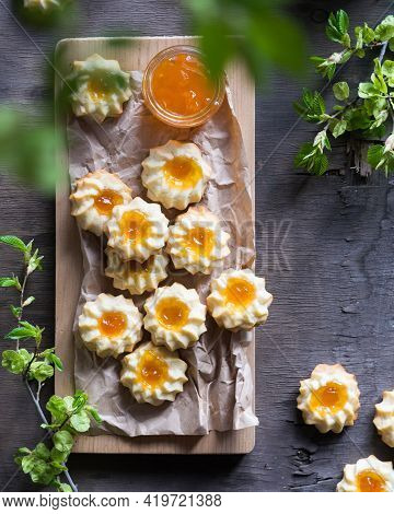 Homemade Shortbread Cookies Qurabiya With Orange Jam In The Center On A Baking Paper On Grey Wooden 
