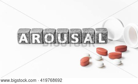 Word Arousal Is Made Of Stone Cubes On A White Background With Pills. Medical Concept Of Treatment, 